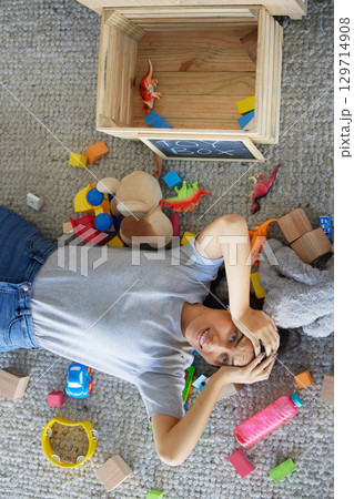 Stress, mother or toys in messy living room for spring cleaning, housekeeping or tidy maintenance in top view. Anxiety, mental health or burnout mom and children play objects in Brazilian family home 129714908