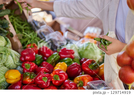 Vegetables, outdoor market with woman and shopping, customer with food for nutrition and wellness, healthy diet and vegetable choice. Retail, grocery shopping and marketplace, healthy food discount. 129714919