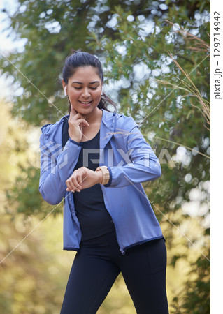 Fitness, runner heart rate and woman watch run time in nature park doing sports and workout. Exercise, wellness and running training of an athlete checking digital smartwatch for performance Fitness, runner heart rate and woman watch run time in nature park doing sports and workout. Exercise, wellness and running training of an athlete checking digital smartwatch for performance 129714942