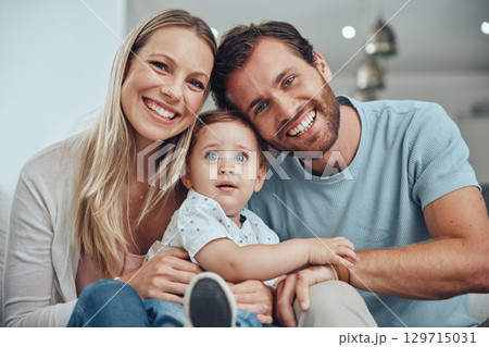 Happy, smile and portrait fo family on sofa for bonding, affectionate and quality time. Relax, support and care with face of parents and baby in living room at home for calm, health and happiness 129715031