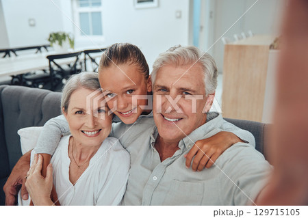 Family, love and selfie on sofa in home, having fun and bonding. Hug, portrait and grandpa, grandmother and girl taking pictures for profile picture, social media and happy memory together in house Family, love and selfie on sofa in home, having fun and bonding. Hug, portrait and grandpa, grandmother and girl taking pictures for profile picture, social media and happy memory together in house 129715105