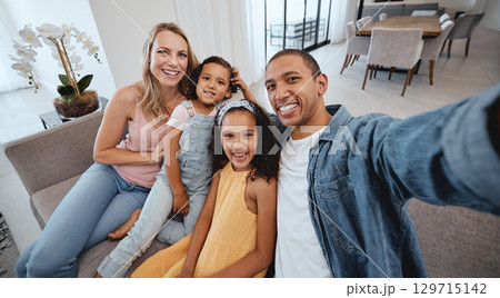 Family selfie, children and portrait on living room sofa for bonding, happiness or love on social media. Interracial happy family, digital picture or smile together on social network in San Francisco 129715142