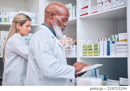 Pharmacy, stock and digital tablet for inventory by man and woman checking medicine and packing shelves. Pharmacist, senior man and online search on device app for information, prescription and pills 129715294