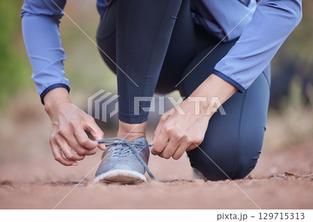 Start, running and feet of a woman in nature, training motivation and cardio fitness in Colombia. Ready, shoes and hands of an athlete tying laces for workout, exercise or hiking in a park for health Start, running and feet of a woman in nature, training motivation and cardio fitness in Colombia. Ready, shoes and hands of an athlete tying laces for workout, exercise or hiking in a park for health 129715313