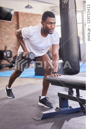 Gym, black man and dumbbell training, rowing exercise and healthy workout in fitness club. Strong bodybuilder guy row with weights, motivation and energy for sports, muscle power and body wellness 129715413