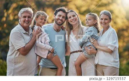 Love, family and grandparents with girls, parents and smile together for bonding, loving and garden. Portrait, grandmother and grandfather with mother, father and daughters for vacation and park. 129715537