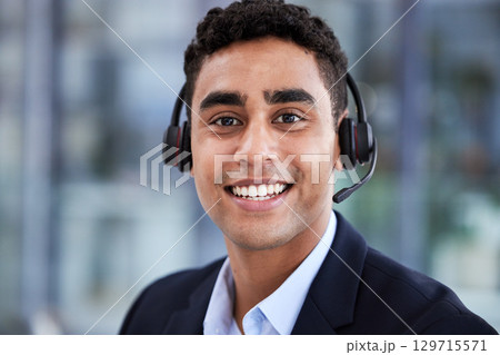 Telemarketing, happy portrait and indian businessman smile in call center agency, customer service worker and contact us consultant. Crm customer support, help desk employee and corporate happiness 129715571