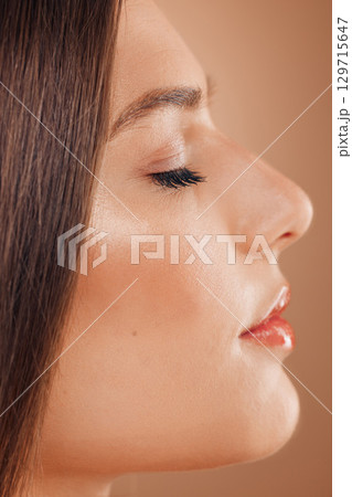 Woman, skincare beauty and face profile in studio for cosmetics makeup, luxury skin wellness or natural glow. Self care dermatology, salon facial treatment and model side profile in beige background 129715647