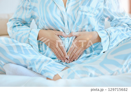 Woman, heart hands or pregnant tummy in bedroom of house, home or nursery hospital in family planning, love or baby trust. Mother, pregnancy announcement or parent touching belly for children growth Woman, heart hands or pregnant tummy in bedroom of house, home or nursery hospital in family planning, love or baby trust. Mother, pregnancy announcement or parent touching belly for children growth 129715682