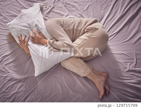 Top view, depression and sad woman with pillow, bedroom and insomnia, anxiety problem and crying. Depressed, tired and sick lady in sleepless night, fear and mental health stress, scared and burnout 129715709