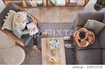 Top view, psychologist and patient woman in consultation office, lounge sofa or talking for anxiety. Senior therapist, depression or mental health for client girl, conversation or discussion above 129715719