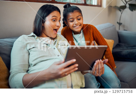 Tablet, pregnant mother and girl on technology looking at children education development app. Learning video, relax and happy family together on a home living room sofa watching a cartoon with mama 129715758