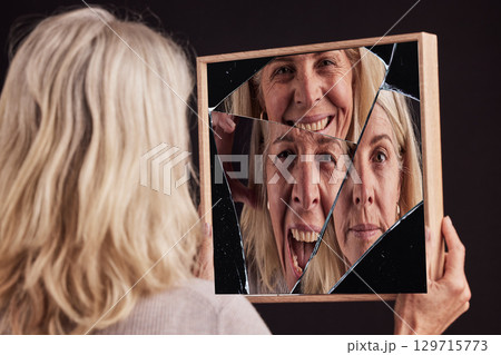 Bipolar woman, broken mirror or reflection of anxiety, depression or psychology, identity crisis or schizophrenia. Depressed face, sad or mature female with mental health, problem or black background 129715773