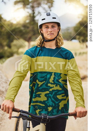 Mountain bike, portrait and man in nature or park for outdoor training, sports competition or fitness goals in Canada with youth lifestyle. Athlete cycling with bicycle and safety helmet for exercise Mountain bike, portrait and man in nature or park for outdoor training, sports competition or fitness goals in Canada with youth lifestyle. Athlete cycling with bicycle and safety helmet for exercise 129715950