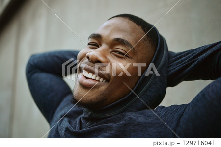 Portrait, black man and outdoor for exercise, smile and workout for fitness, wellness and health. African American male, athlete and runner on break, relax and happy on weekend, calm or peace in city 129716041