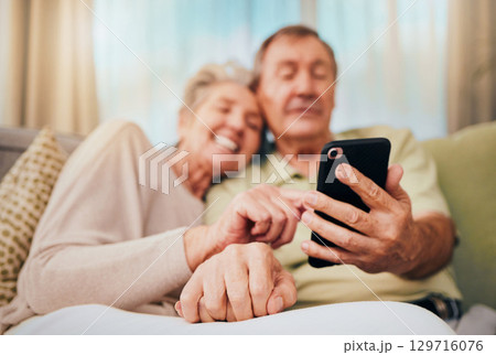 Relax, search and phone with old couple on sofa for communication, social media and internet. Bonding, rest and quality time with man and woman in home living room for digital, technology and mobile Relax, search and phone with old couple on sofa for communication, social media and internet. Bonding, rest and quality time with man and woman in home living room for digital, technology and mobile 129716076