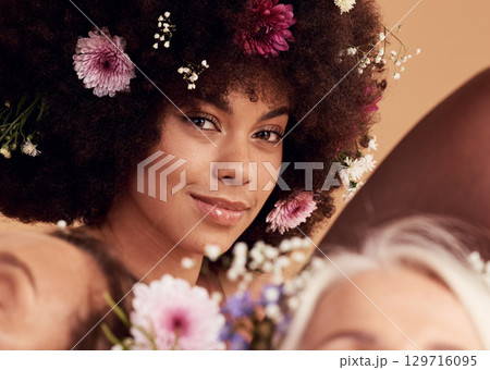 Black woman, flowers and smile for beauty portrait in studio for skincare wellness, luxury makeup aesthetic and cosmetics hair care. Spring floral art, happiness and facial care or dermatology glow 129716095