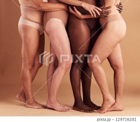 Diversity, legs and body positivity, women in underwear huddle together on studio background. Feet, friends and health, empowerment in self love and care in global community of diverse female bodies. 129716201