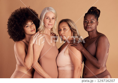 Beauty, diversity and group of women in lingerie in studio on a brown background. Underwear, makeup or cosmetics of body positive friends or female models posing for feminine empowerment or self love 129716207