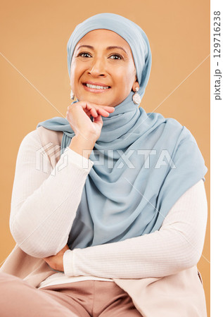 Mature muslim woman, face and fashion hijab on studio background with religion empowerment, traditional ideas or human rights innovation. Happy portrait, middle aged islamic model with Iranian scarf 129716238