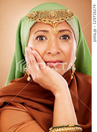 Portrait, muslim and beauty with a model woman in studio on a beige background for skincare or tradition. Face, fashion and culture with an attractive maturre islamic female proud of her heritage 129716274