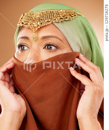 Muslim, skincare and woman with hijab in studio for beauty, wellness and cosmetic treatment on brown background. Islam, girl and model in face scarf relax with pamper, grooming and wellness in Dubai Muslim, skincare and woman with hijab in studio for beauty, wellness and cosmetic treatment on brown background. Islam, girl and model in face scarf relax with pamper, grooming and wellness in Dubai 129716278