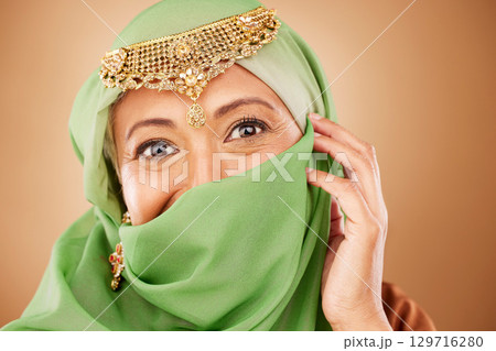 Muslim woman, face or fashion burka on studio background or traditional jewelry, natural makeup cosmetics or religion jewellery. Zoom portrait, happy or mature Islamic model in Dubai aesthetic pride Muslim woman, face or fashion burka on studio background or traditional jewelry, natural makeup cosmetics or religion jewellery. Zoom portrait, happy or mature Islamic model in Dubai aesthetic pride 129716280