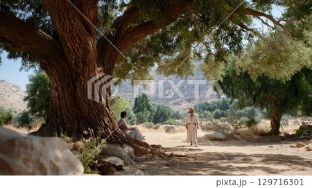 Serene outdoor meeting of two adult men under large tree. 129716301