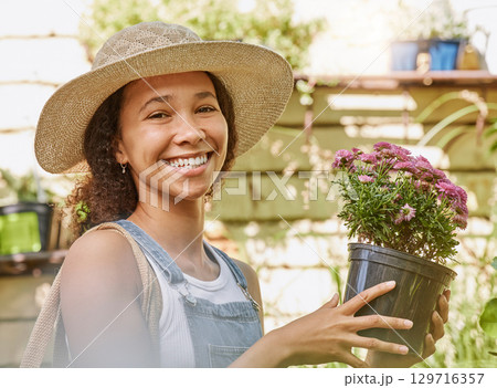 Face, flower pot and black woman shopping in floral shop or nursery. Portrait, sustainability and happy female gardener from South Africa with beautiful flowers after buying at plant store or market. Face, flower pot and black woman shopping in floral shop or nursery. Portrait, sustainability and happy female gardener from South Africa with beautiful flowers after buying at plant store or market. 129716357