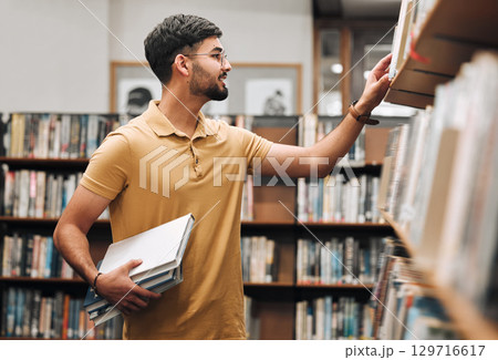 Student man, search bookshelf and library for reading, information and knowledge at university. College student, research and studying for education, college and learning for scholarship in Marseille 129716617