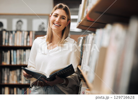 Student, reading or books in library on school, university or college campus for education, study research or learning. Portrait, smile or happy woman, textbook or bookshelf information for homework 129716628