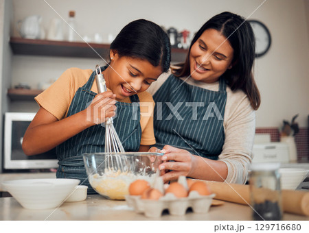 Bakery, baking and woman with girl learning to bake, cooking skill and development with happiness and help. Mother, child with fun activity and teaching to learn with food ingredients in family home. 129716680