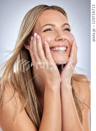 Woman, cosmetics and hair care with smile, relax and treatment on grey studio background. Female, girl and clean scalp for stylish hair, casual or glow for smooth, shine or grooming for style or face 129716713