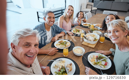 Big family, lunch and selfie with food on table in home dining room. Fine dining, happy memory and grandma, grandpa and father, mother and girls with healthy meal taking pictures for social media. Big family, lunch and selfie with food on table in home dining room. Fine dining, happy memory and grandma, grandpa and father, mother and girls with healthy meal taking pictures for social media. 129716830