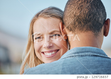 Couple, interracial with hug, love and travel, woman smile with black man, commitment and relationship with outdoor bonding. Face zoom, happy and romance in nature, trust and care with support. 129716837