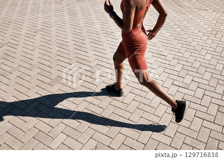 Running, runner and woman with fitness in city, training for marathon and exercise with cardio workout in Seattle. Urban, run outdoor with health and wellness, active life and athlete shadow in sport 129716838