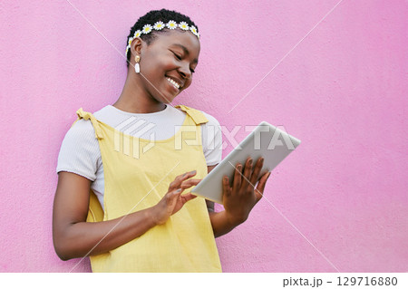 Black woman, tablet and smile of a person on social media with fashion and spring happiness. Flower crown, beauty and style hippie blogger online looking at web and 5 internet for digital blog Black woman, tablet and smile of a person on social media with fashion and spring happiness. Flower crown, beauty and style hippie blogger online looking at web and 5 internet for digital blog 129716880