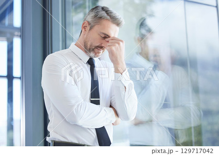 Window, business man and stress with headache, burnout and overworked in office. Senior male, entrepreneur and ceo frustrated, mental health and leader with depression, pain and tired in workplace. Window, business man and stress with headache, burnout and overworked in office. Senior male, entrepreneur and ceo frustrated, mental health and leader with depression, pain and tired in workplace. 129717042