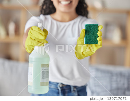 Sponge, spray and woman with cleaning products in home for hygiene, health and wellness. Spring cleaning, housekeeper and happy female holding equipment for washing, sanitizing or disinfecting house. 129717071