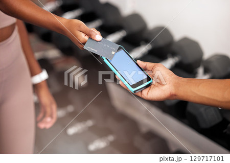 Payment, machine and woman with a credit card at the gym for a fitness contract or purchase. Card, bill and girl paying her personal trainer after training, workout or exercise at a sports center. 129717101