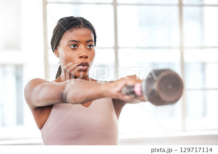 Fitness, breathing and black woman with kettlebell, body builder and weight training in gym, exercise and focus. Athlete, weightlifting and breath with wellness and strong, muscle and workout studio. 129717114