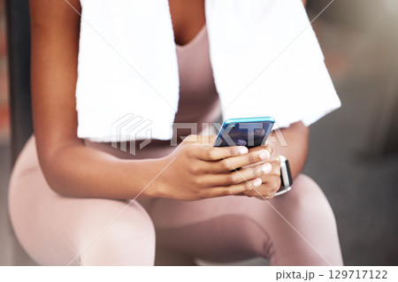 Fitness, hands and woman with phone texting, chatting or social media on a break from workout exercise at the gym. Hand of active female typing message, conversation or communication on smartphone Fitness, hands and woman with phone texting, chatting or social media on a break from workout exercise at the gym. Hand of active female typing message, conversation or communication on smartphone 129717122
