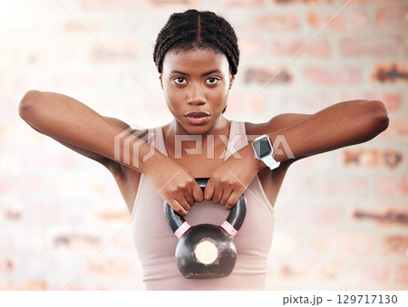 Black woman, fitness and kettlebell with focus and exercise in gym, weights and muscle training with strong athlete and bodybuilding. Bodybuilder, workout and sport motivation with wellness portrait. Black woman, fitness and kettlebell with focus and exercise in gym, weights and muscle training with strong athlete and bodybuilding. Bodybuilder, workout and sport motivation with wellness portrait. 129717130