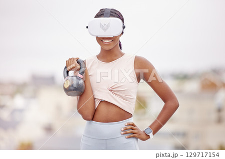 Woman, kettlebell or virtual reality headset in workout, training or exercise in city on fitness software, esports or metaverse challenge. Smile, happy or sports person in vr futuristic weightlifting 129717154