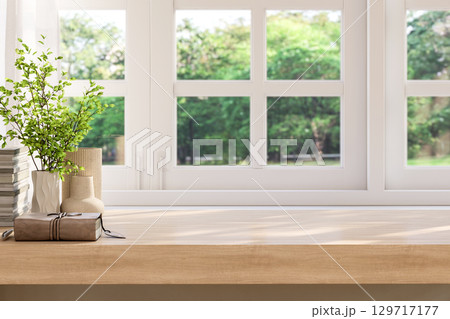 Blank top wooden table located by window decorated with old book and plant in vase 3d render 129717177