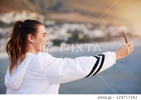 Beach selfie, happy and woman with a phone for video call, communication and social media update on holiday in Bali. Travel influencer, smile and girl with mobile photo on an ocean vacation in summer 129717262