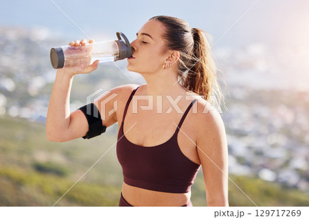 Water, fitness and drink water after hiking, workout and challenge for health, wellness or nutrition. Young sports, athlete or runner woman with water bottle for exercise, training or hydrate outdoor Water, fitness and drink water after hiking, workout and challenge for health, wellness or nutrition. Young sports, athlete or runner woman with water bottle for exercise, training or hydrate outdoor 129717269
