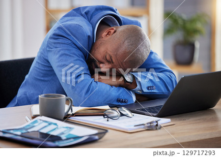 Tired, professional burnout and black man sleep at desk, mental health and depression with sick businessman, corporate and exhausted. Sleeping, work and insomnia, business, fatigue and rest in office Tired, professional burnout and black man sleep at desk, mental health and depression with sick businessman, corporate and exhausted. Sleeping, work and insomnia, business, fatigue and rest in office 129717293