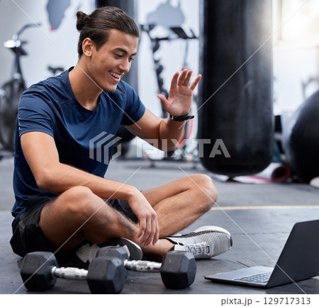 Man, laptop and wave for video call in gym with smile rest on floor after training session. Guy, wellness and pc break during workout for fitness, health or sport with happiness on online webinar 129717313