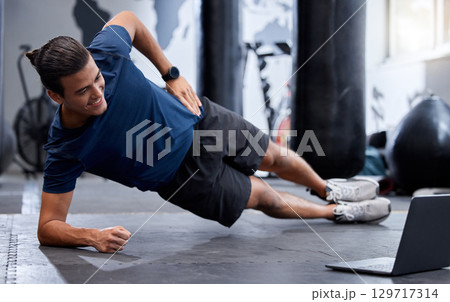 Fitness, exercise and laptop for virtual workout class with personal trainer training online for audience on health and wellness blog. Man at gym for webinar to train asking followers to subscribe 129717314